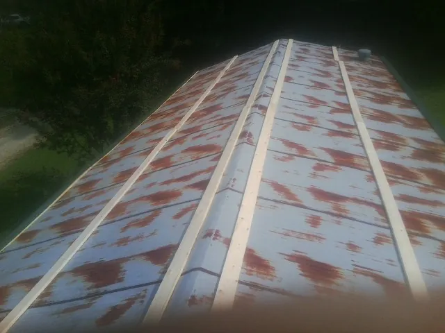 Rusted metal roof panels with new wood purlins before replacement — Storm Damage Roof Repair in Mishicot by Roofing Brothers